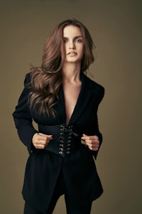 a woman in a black suit posing for a photo