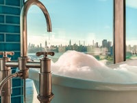 a bathtub in a bathroom with a view of a city
