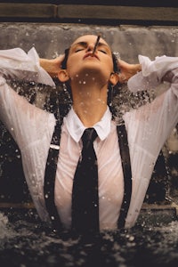 a woman wearing a tie and suspenders