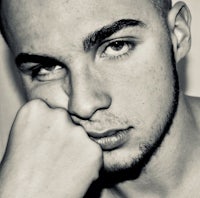 a man with a shaved head is posing for a photo