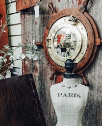 a wooden mannequin with a ship's wheel on it