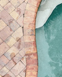 a pool with a brick ledge
