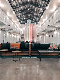 the interior of a prison building with couches and tables