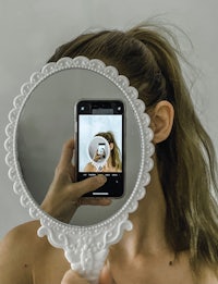 a woman taking a selfie in a mirror