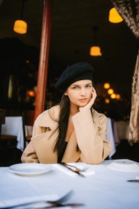 a woman sitting at a table in a restaurant